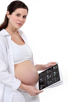 Pregnant woman holding scan