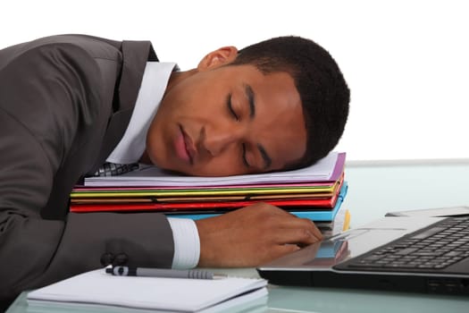 Worker sleeping on a stack of folders