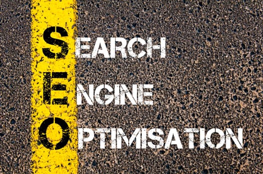 Acronym SEO - Search Engine Optimisation. Business Conceptual image with yellow paint line on the road over asphalt stone background.