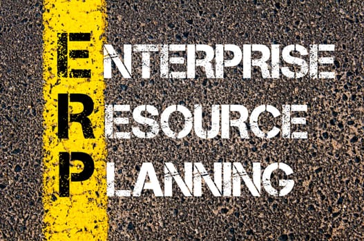 Acronym ERP - Enterprise Resource Planning. Business Conceptual image with yellow paint line on the road over asphalt stone background.