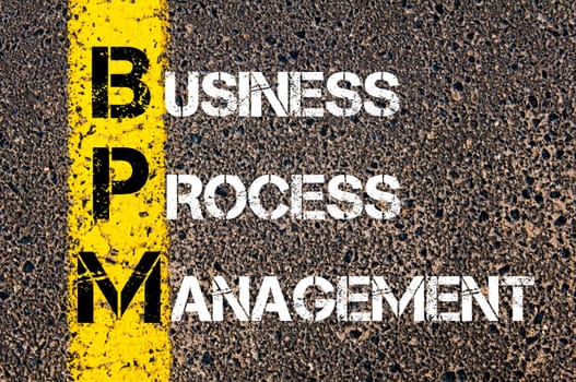 Acronym BPM - Business Process Management. Business Conceptual image with yellow paint line on the road over asphalt stone background.