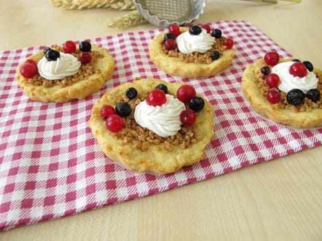 Almond tartlettes with cream and berries