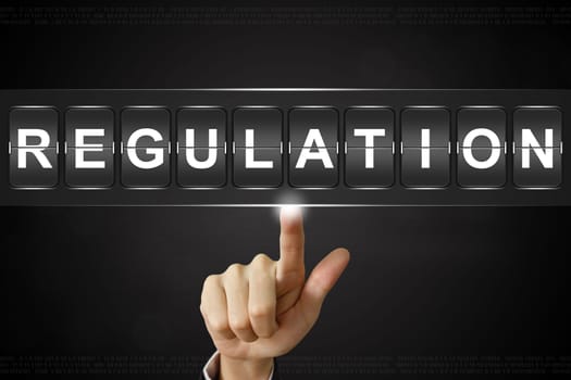 business hand pushing regulation on Flipboard Display