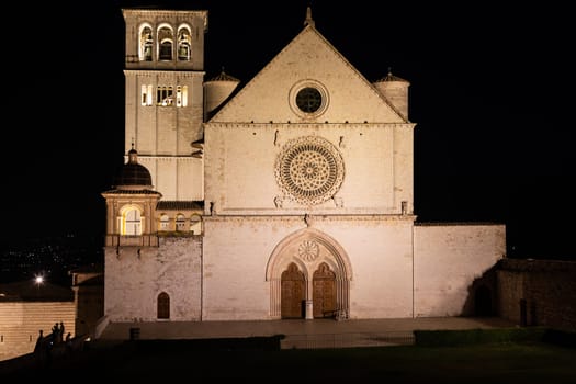 Assisi Basilica by night in Umbria region, Italy. The town is famous for the most important Italian St. Francis Basilica (Basilica di San Francesco)