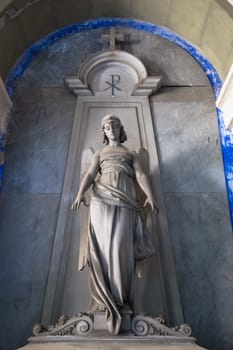 GENOA, ITALY - June 2020: antique statue of angel (beginning 1900, marble) in a Christian Catholic cemetery - Italy