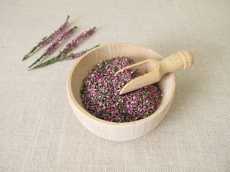 Dried flowers from heather herb in a wooden bowl
