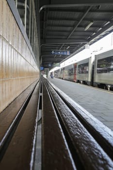 Rail tracks and trains in the Brussels South Railway Station
