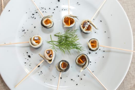 Vinegar pickled anchovies brochettes rolled with jelly. Selective focus