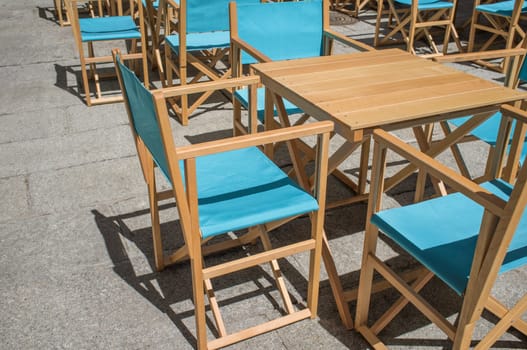 Downtown restaurant terrace with folding canvas chairs. Terrace restaurant furniture concept