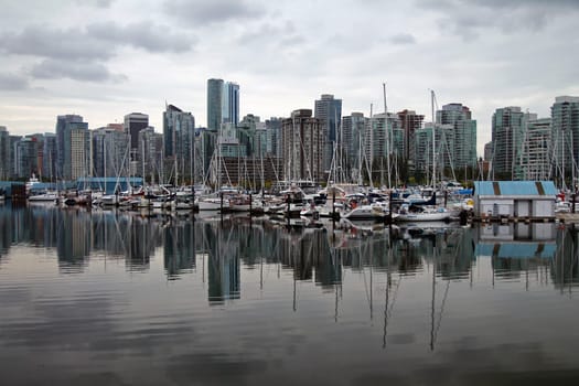 Dramatic sky on the boats and skyscrapers of Vancouver marina in British Columbia