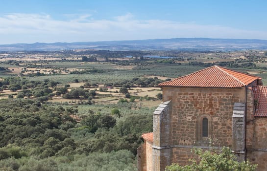 Parish Church of Santa Marina with San Marcos Dam at bottom. Aceituna, Alagon Valley. Caceres, Extremadura, Spain