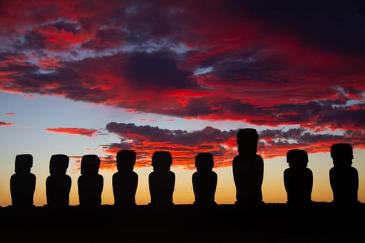 Dramatic colorful sunrise over Moai stone sculptures at Ahu Tongariki, Easter island, Chile