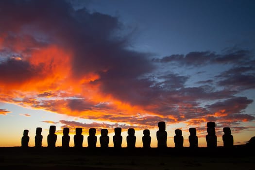Dramatic colorful sunrise over Moai stone sculptures at Ahu Tongariki, Easter island, Chile