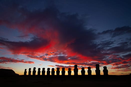 Dramatic colorful sunrise over Moai stone sculptures at Ahu Tongariki, Easter island, Chile
