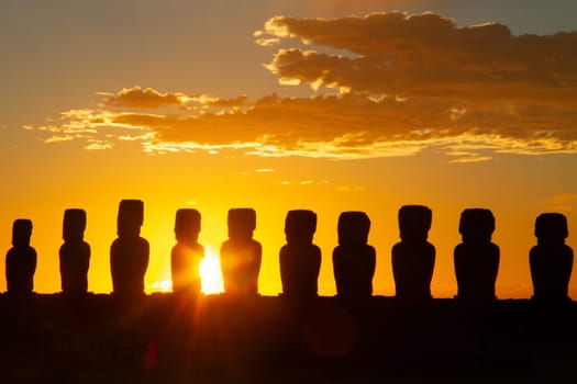 Dramatic colorful sunrise over Moai stone sculptures at Ahu Tongariki, Easter island, Chile