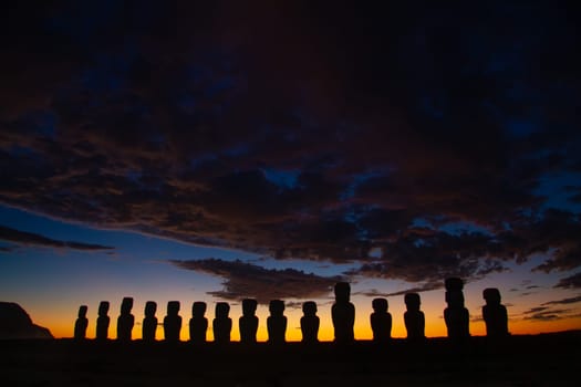 Dramatic colorful sunrise over Moai stone sculptures at Ahu Tongariki, Easter island, Chile