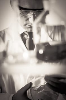 Chemical laboratory. Chemist searching for the red indicating solution.