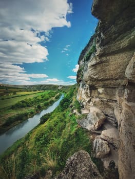 Idyllic landscape with Raut river flowing through the canyon hills, karst cliffs at Orheiul Vechi, old Orhei complex, near Butuceni village, Moldova.
