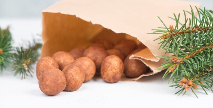 Marzipan potatoes, in german called Marzipankartoffeln, with cacao powder, sweets for christmas, empty copy space