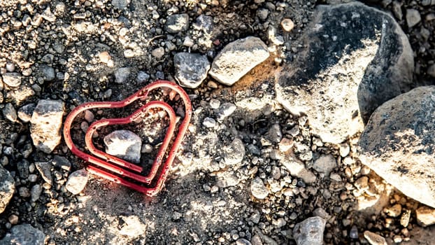 Broken Paper Clip lying on the dirty lane. .Symbol photo for getting divorced.