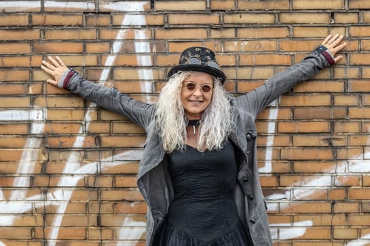 Beautiful Steam Punk Lady standing on a Brick Wall Background