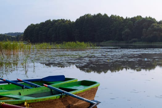 landscape with two wooden boats on the river in Belarus