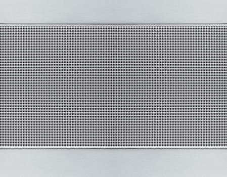 Spot lit perforated metal plate. Metal background close-up
