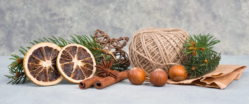 Christmas items like dried oranges, hazelnuts, fir branch, empty copy space
