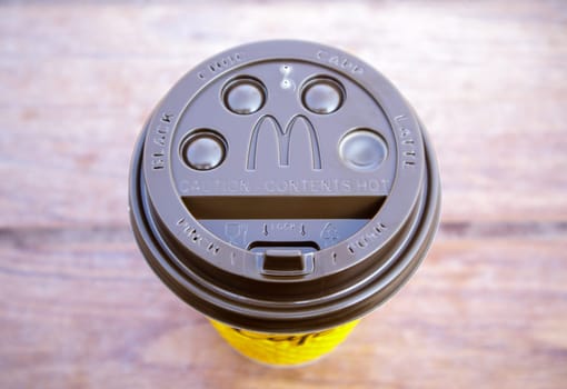 Plastic brown or black disposable top coffee lid with McDonald's fast food restaurant logo close up. Disposable coffee cup. Takeaway beverage cup. View from above. Ukraine, Kiev - September 13, 2021