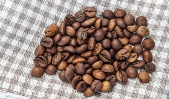 Close-up of roasted fresh coffee beans. Group of brown or black coffee beans background