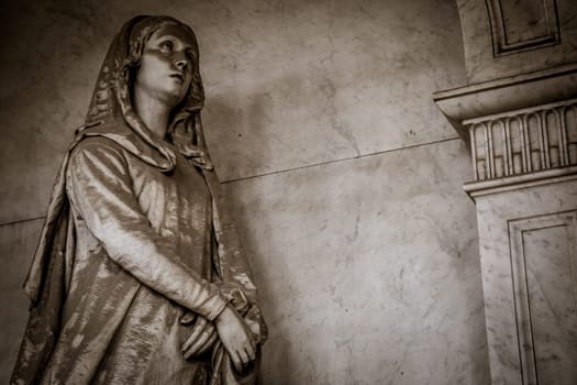 GENOA, ITALY - June 2020: antique statue, beginning 1800, made of marble, in a Christian Catholic cemetery - Italy