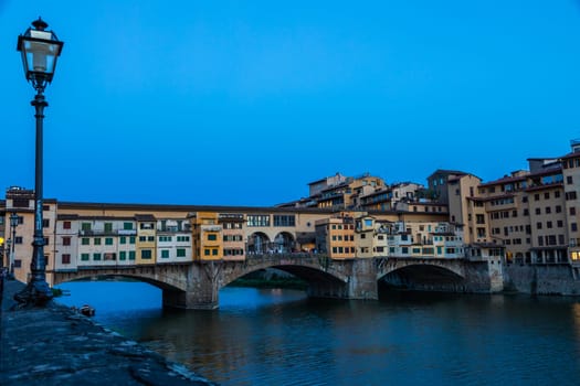 Florence, Italy - Circa June 2021: sunset on Ponte Vecchio - Old Bridge. Amazing blue light before the evening.