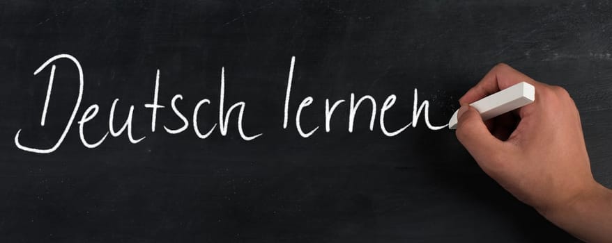 The words learn german are standing in the german language on a blackboard