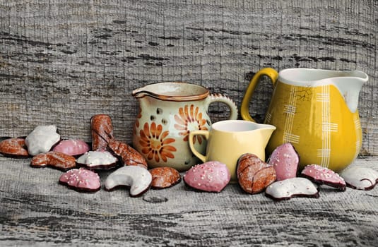 Colorful gingerbread and old coffee pots on a wooden background