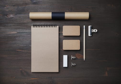 Blank kraft business stationery set. Corporate identity template on wooden background. Flat lay.