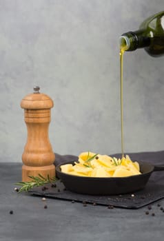 Potatoes in a pan with rosmarine, pepper and olive oil