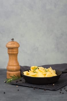 Potatoes in a pan with rosmarine, pepper and olive oil