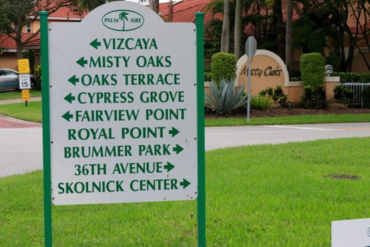 Pompano Beach, FL, USA - October 11, 2020: Road sign in Palm Aire, a large community with a lot of retired people. Sign showing ways to various places in a golf course community in part of Palm Aire.