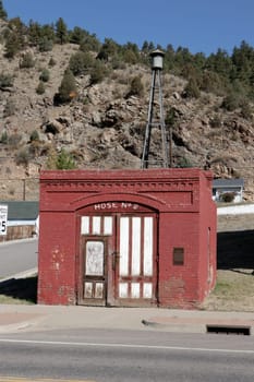 Idaho Springs, CO, USA - October 7, 2020: Located at 600 Colorado Blvd, fire hose cart house built around 1882. Hose House building that kept fire wagon in the western town with siren tower in back.