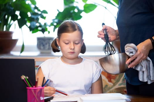 Distance learning concept. Mother helps her daughter to do school homework, using digital tablet, e-learning concept, home education.