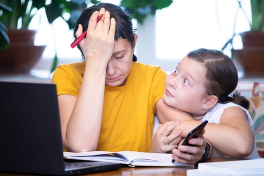 Exhausted woman working from home during quarantine. Home office and parenthood at same time.