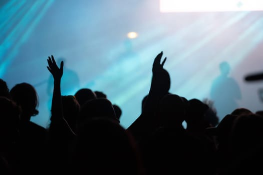 Crowd at concert - Cheering crowd in bright colorful stage lights