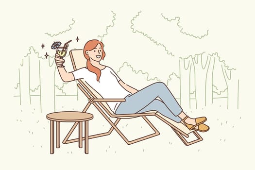 Relaxation and leisure activity concept. Smiling pretty woman cartoon character sitting in deck chair drinking fancy cocktail relaxing alone outdoors vector illustration