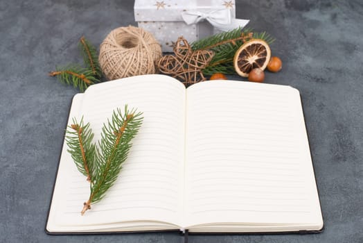 Empty notebook with christmas decoration, branch of fir, nuts, stars and spice