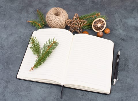 Empty notebook with christmas decoration, branch of fir, nuts, stars and spice
