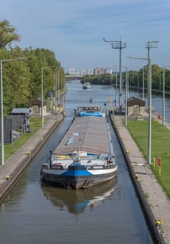 Cargo ship at the entrance to the Frankfurt-Griesheim lock, Germany