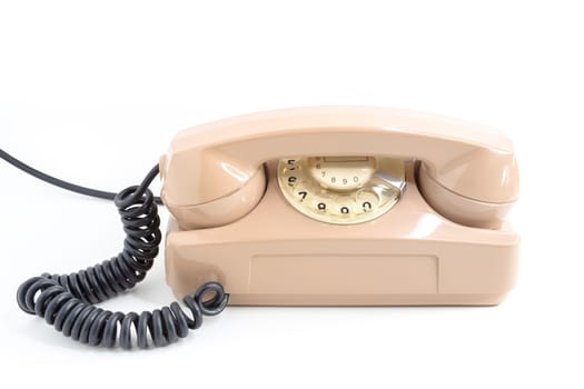 Vintage telephone. Pink old telephone isolated on white background.