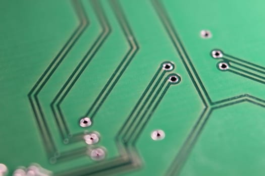 Electronic board with circuit lines and chip. Macro view of green board