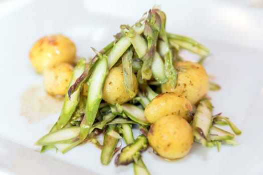 Baked potatoes with raw artichokes. Delicious vegan dish. Close-up. Shallow DOF.