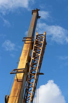telescopic mast Elevator crane in blue sky low angle view